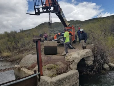 Crew from Last Chance Ditch performing maintenance on the ditch.